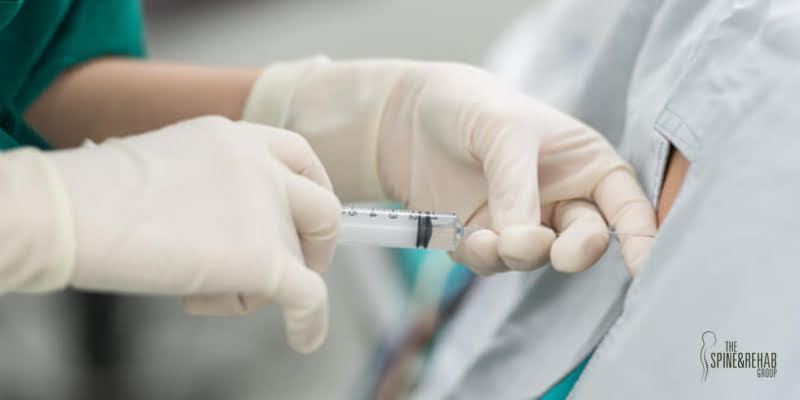 Doctor injects epidural steroid injection into a patient's spine.