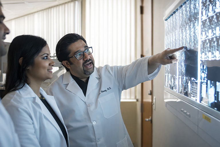 Doctors consulting with patient at The Spine and Rehab Group providing personalized pain management care